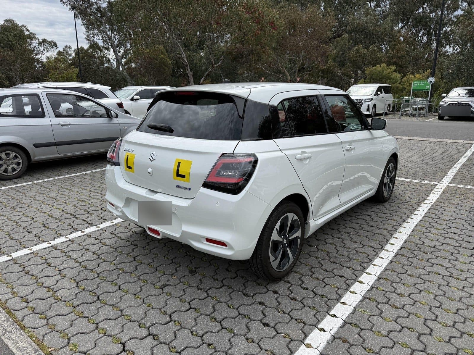 The Suzuki Swift from behind, with yellow L plates
