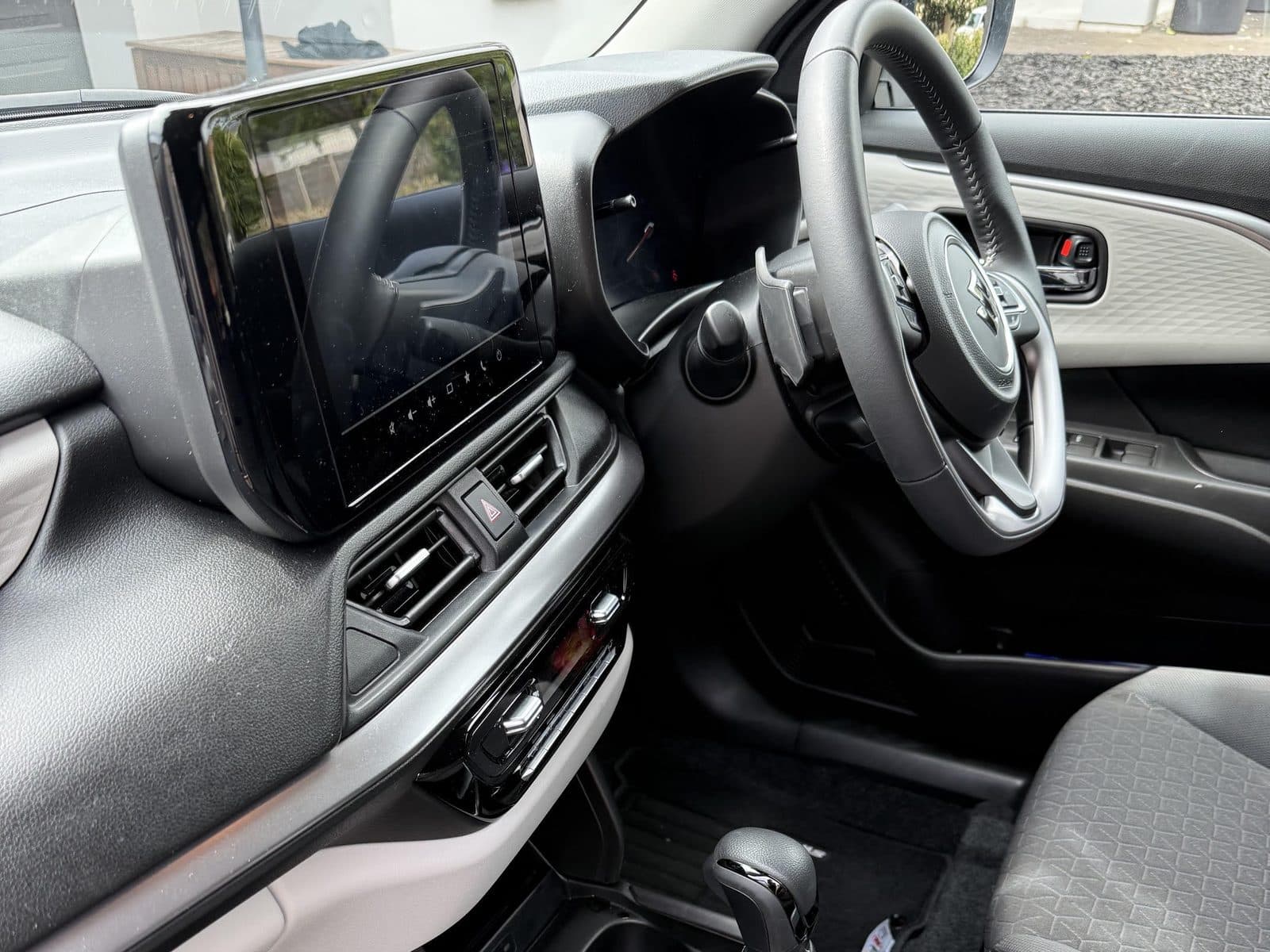 Inside the Suzuki Swift: steering wheel, touchscreen and automatic gear selector
